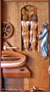 A carved panel in the wood sculpture "The Holy Family" Depicted is a scene in the family's carpenter shop at Nazareth, with Jesus as an adult with Joseph and Mary, the eve before leaving to begin his ministry (extra-biblical) 