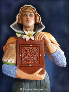 A closeup view of Saint Dymphna, the patron saint of mental illness, is a life-size statue carved in tropical cedar by A.VonnHartung for St. Joseph Church in New London Connecticut 